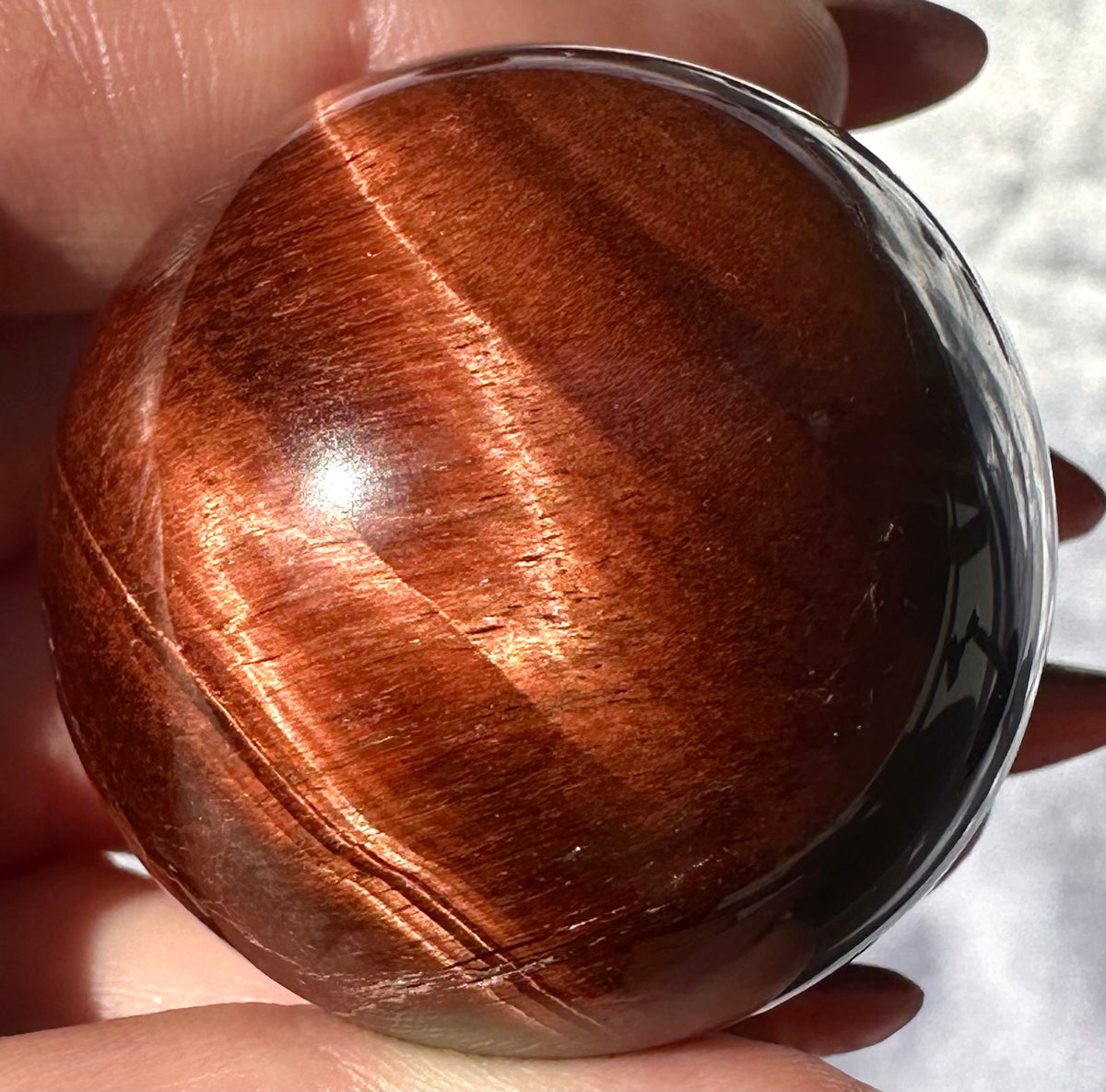 Sphere in red tiger's eye (or bull's eye)